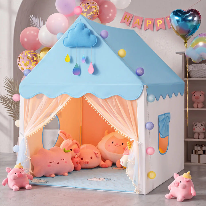 A pink ToyHare princess play tent shaped like a house, featuring scalloped trim, pom-pom curtains, and a cloud appliqué, filled with plush toys in a festive party setting with balloons and a &
