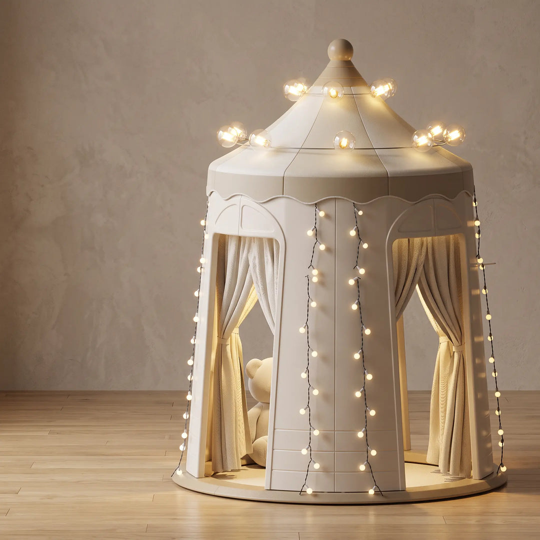 Beige and cream ToyHare indoor playhouse castle with string lights, curtains, and decorative roof lights, shown from the front.