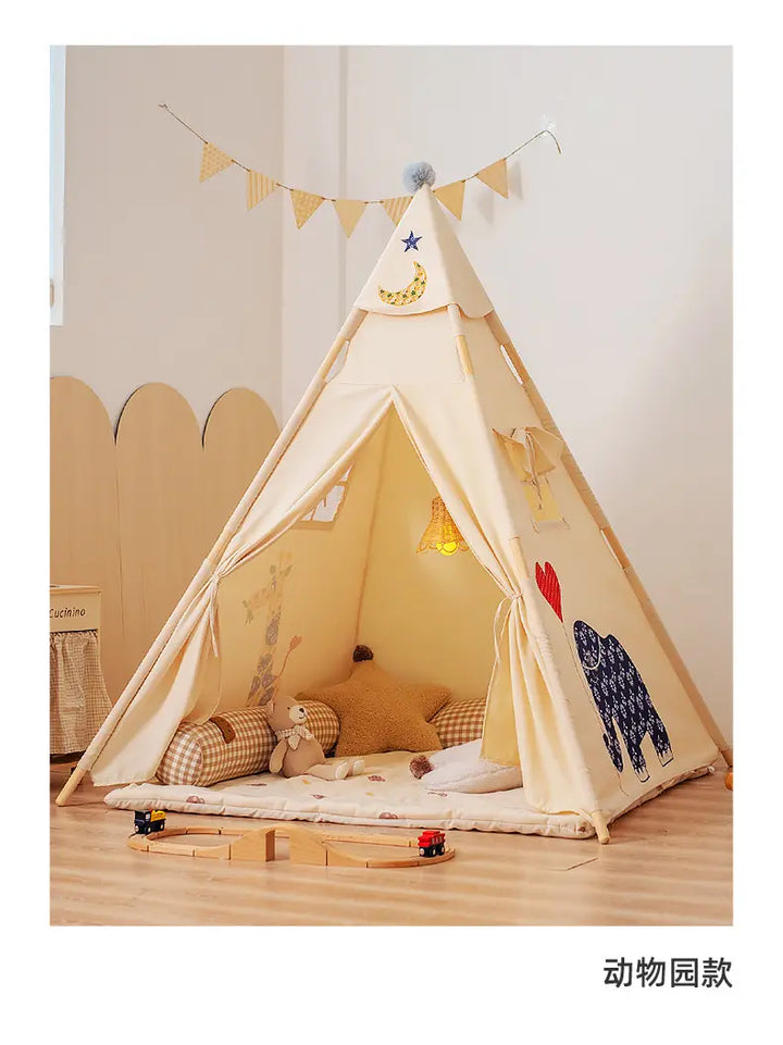 Cozy ToyHare canvas teepee play tent for kids, featuring an embroidered bear, pom-pom topper, tie-back windows, and a soft interior with cushions and toys.
