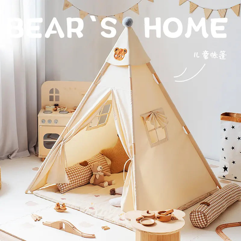 ToyHare cream canvas teepee play tent for kids, featuring an embroidered bear motif, pom-pom topper, tie-back door, and windows, set up in a cozy play area with toys and decor.