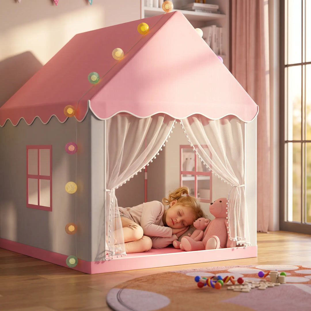 A young girl sleeps peacefully inside a pink and grey ToyHare Princess Castle play tent, adorned with colorful LED fairy lights and sheer white curtains.
