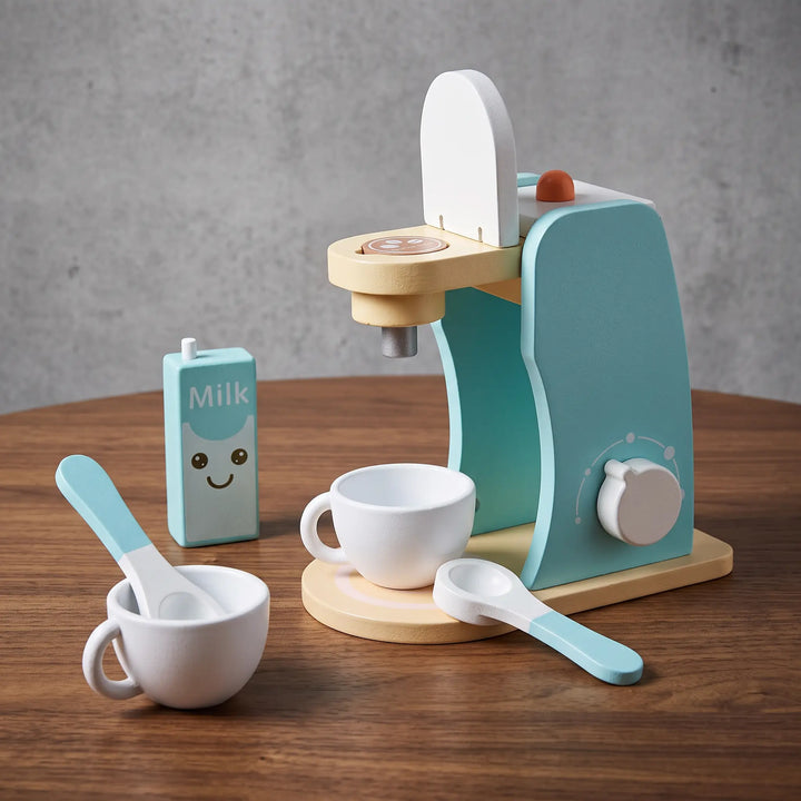 ToyHare wooden toy coffee maker set with milk carton, cup, and spoons on a wooden table surface.