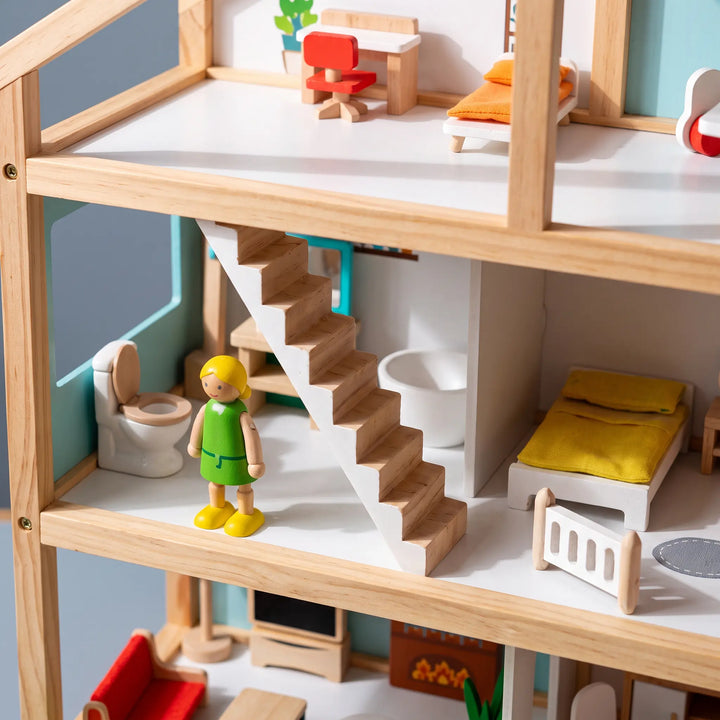 Close-up interior view of a three-story wooden dollhouse, showcasing detailed rooms with miniature furniture, a small wooden figure, and stairs.